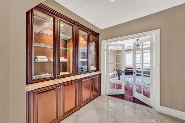 On the opposite side of the balcony, this alcove with built-in linen storage leads to the double door entry to the enormous bonus room.