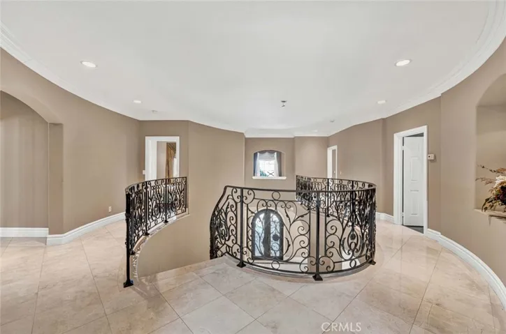 In this view of the upper balcony, you see the doorway to the ensuite bedroom to the left, the opening to the cubby for a computer desk or reading room in the center and then the doors to the Jack 'n Jill bedrooms to the right.