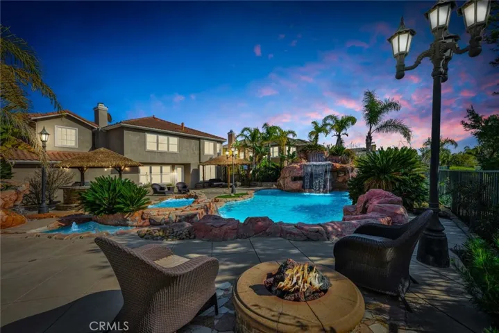 Your backyard oasis includes an amazing rock bordered pool with 2 spas, 1 of which is hidden behind the waterfall making it an amazing grotto! There's an outdoor kitchen with a viking bbq and 2 burners,a sink and a fridge.
