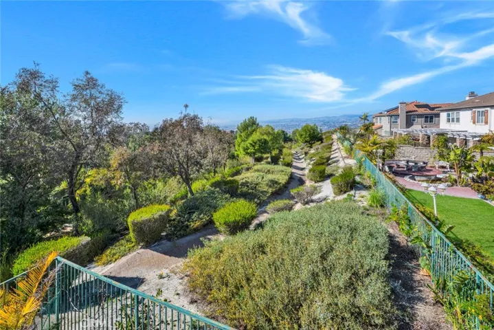 Here's the view from the back right corner sitting area with fire pit. Lots of lush green and a view of the hills of Yorba Linda, city lights too!