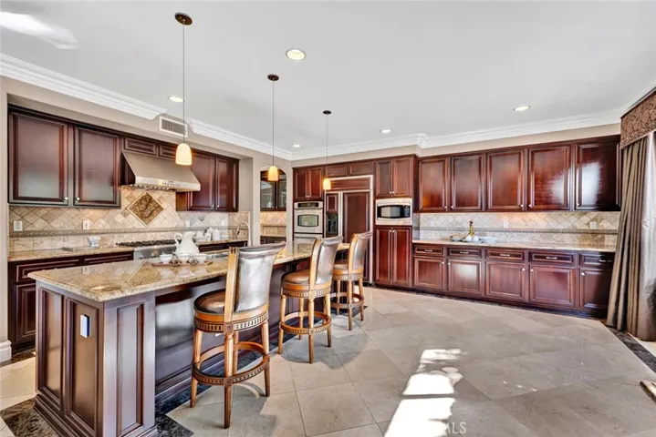 A truly grand kitchen with bar seating and a breakfast room all open to the family room, creating a great room.