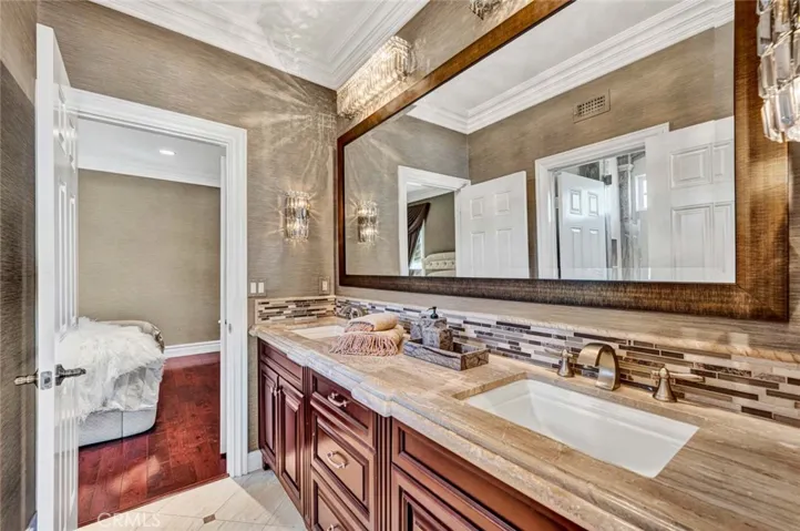 This is the Jack 'n Jill bath with double vanities a large mirror, doors from both bedrooms and to the left in the picture is a privacy door to the commode and tub/shower combo.