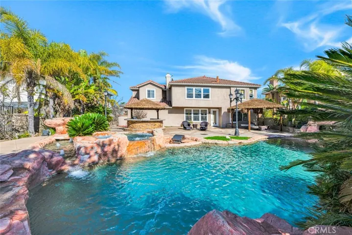 This view shows the back of the home and the open air spa at ground level. See the mini kitchen to the right of the spa? Just in front of that are the swim up stools for the bar.