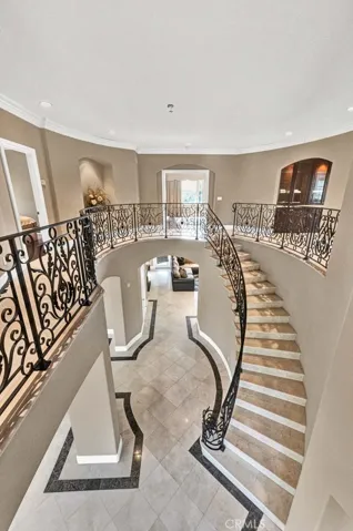 A full view of the entry and upper level balcony. The owner's suite is in the center of the picture. To the left is a lovely art niche and then the Jack 'n Jill bedrooms. To the right is the entry to the huge bonus room and to the far right is the ensuite bedroom.