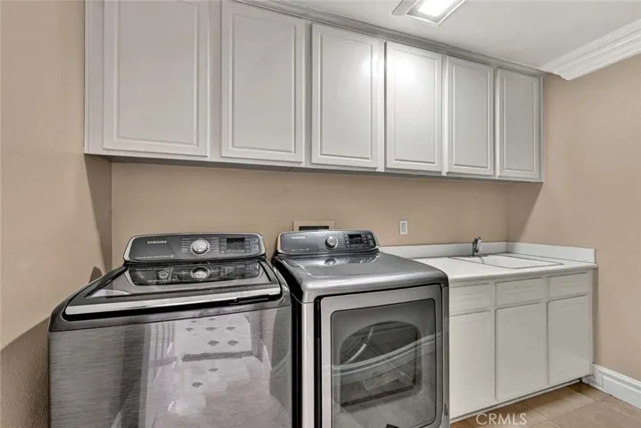 The laundry room has ample space for storing supples, extra towels, etc. and a handy sink for pretreating.