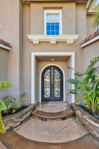 Before you enter, you see the gorgous wrought iron arched double doors with lovely scroll work.