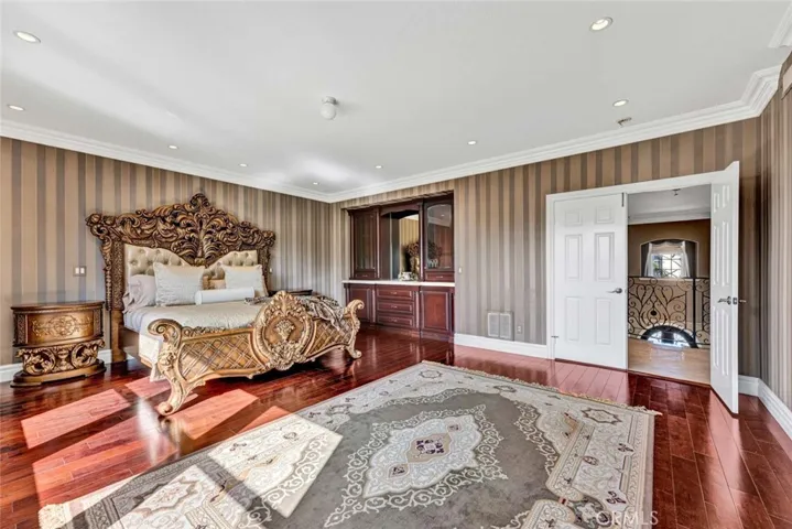 This view shows the double door entry and the upstairs balcony and also the built-in desser and plenty of room for other furnishings.