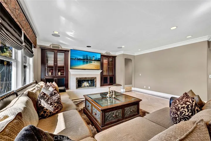Looking into the spacious family room, there's plenty of room for your home theater and ample seating space. Note the recessed lighting  and built-in speakers.