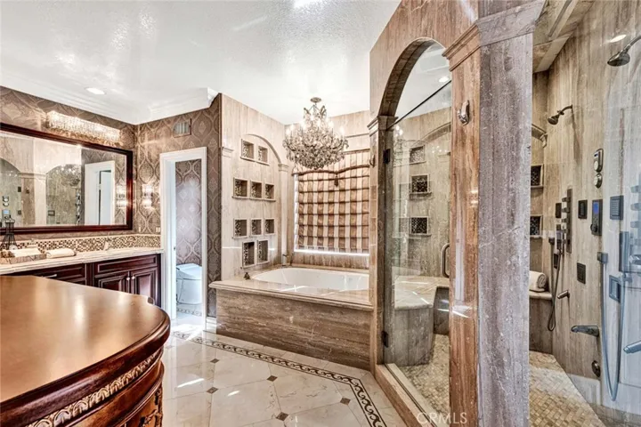This opulent bath is like visiting a day spa everyday. There's a deep jetted soaking tub, private commode, double vanity and room for a large dresser. The shower is absolutely amazing! Take a look at the close ups!