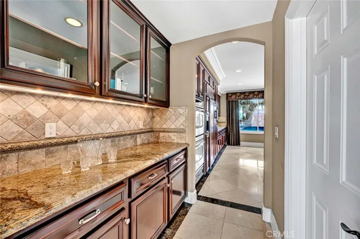 The butler's pantry between the dining room and kitchen adds work and buffet space. The huge walk-in pantry is to the right.