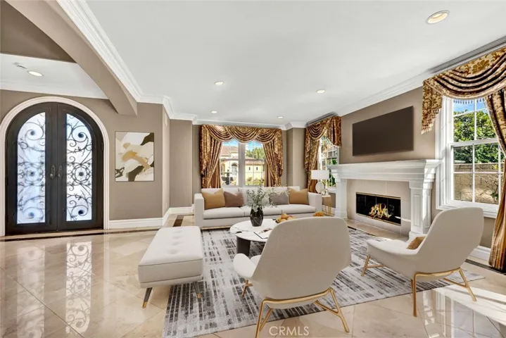 This view from near the dining room looking into the living room shows the size and elegance of this room. This photo has been enhanced with virtual staging.