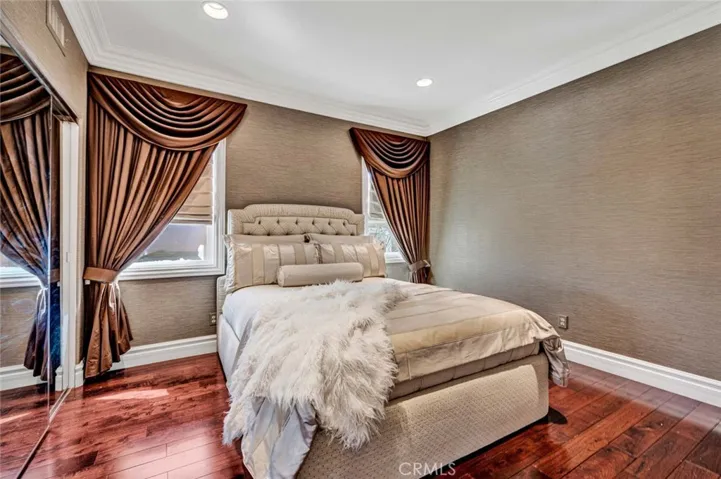 This is the other half of the Jack 'n Jill room, also with recessed lighting, crown moldings, rich wood flooring and this one has a mirrored wardrobe closet.