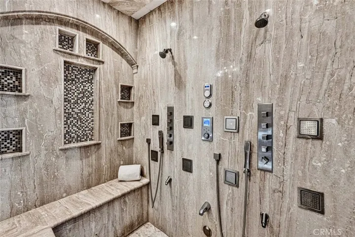 Talk about a full body shower experience, this shower is amazing! There are 2 separate Thermasol shower systems that include wall mounted head, 4 body sprayers, a handheld sprayer, steam shower and a surprise in the ceiling!