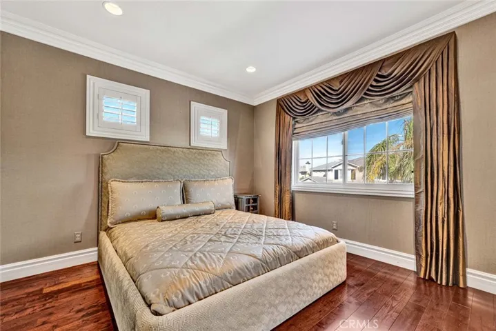 This is the ensuite bedroom on the opposite side from the Jack 'n Jill bedrooms. It also has recessed lighting, rich wood flooring and crown molding.