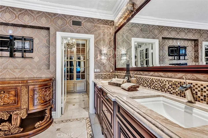 This view shows the big double vanity, a perfect place for a television and the doorway to the huge walk-in closet.
