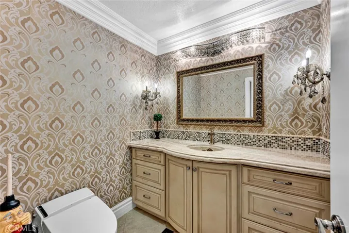 The elegant powder room on the main level. There are so many special features in this home. The lids on the commodes even automatically open when you enter the room and auto flush!
