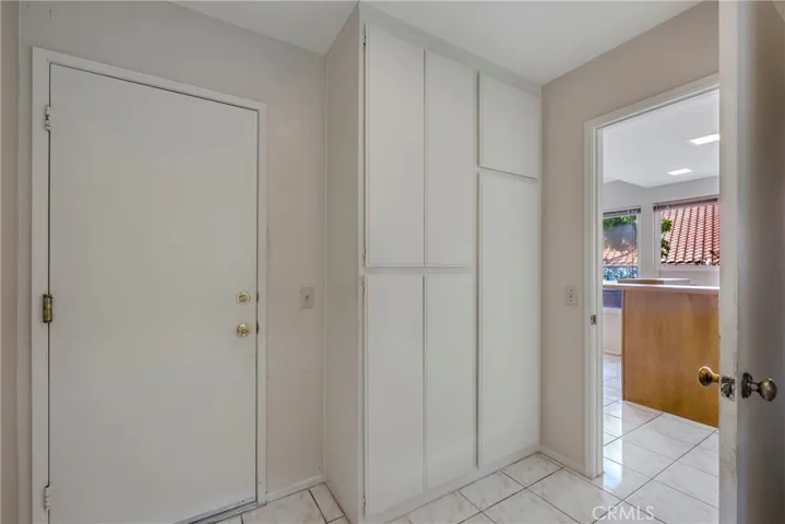 Laundry room leads to kitchen and attached garage.