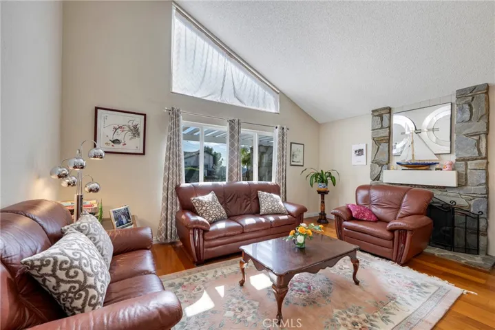 Living room offers wood floors and a fireplace.