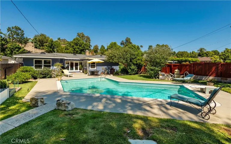 Another view of the backyard, concrete deck around pool