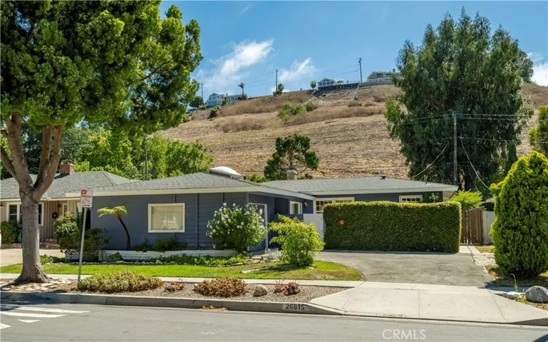 View from street, front yard with lawn and private courtyard behind the bushes