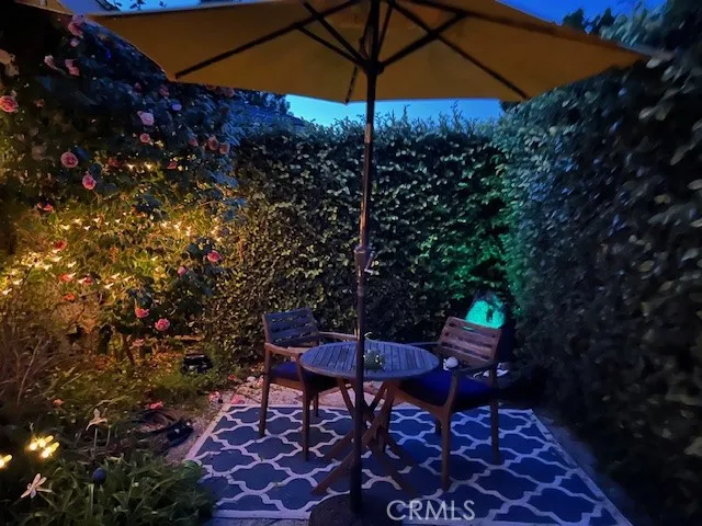 Seating in garden area of front yard, behind a wall of topiaries
