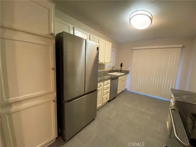 Stainless Steel fridge, Tile Flooring, Dishwasher and garbage disposal