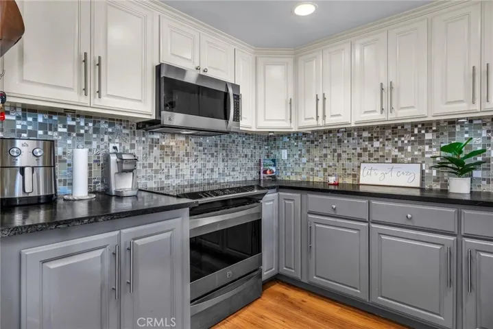 stone counter and mosaic backsplash