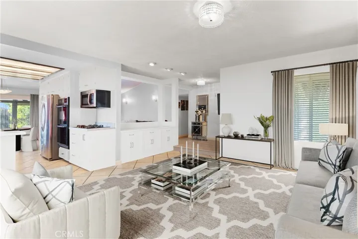 virtually staged living room looking into kitchen as example