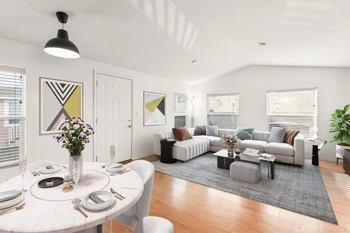 iving Room
An open-concept living space featuring high ceilings and stylish accent walls. Natural light pours in through large windows, highlighting the sleek laminate flooring and contemporary finishes. Room photos has been online staged.