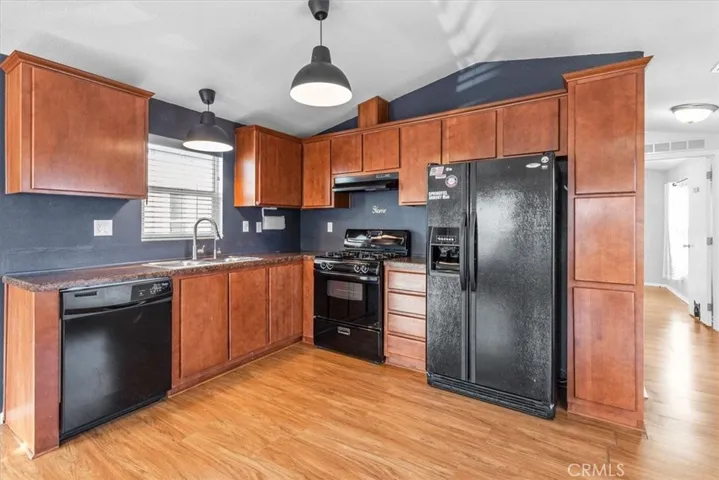 Kitchen
A well-equipped kitchen with upgraded black appliances, including a refrigerator, dishwasher, and range. The compact yet functional layout provides ample counter space and modern cabinetry for storage.