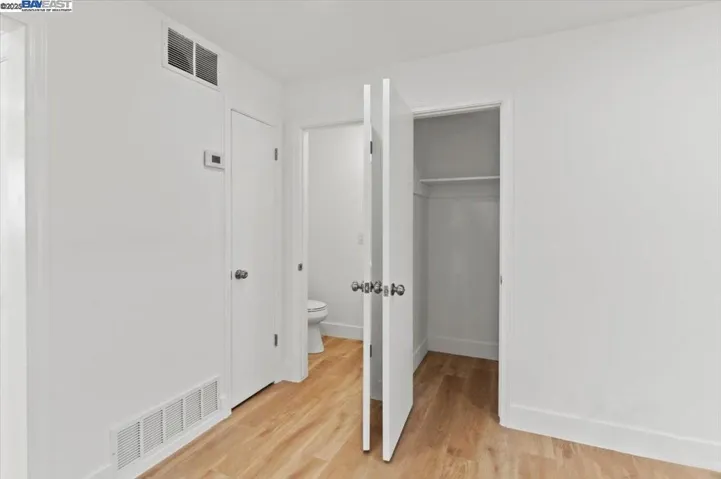 Showing Half Bath and down stairs closet that is under the Stairwell.