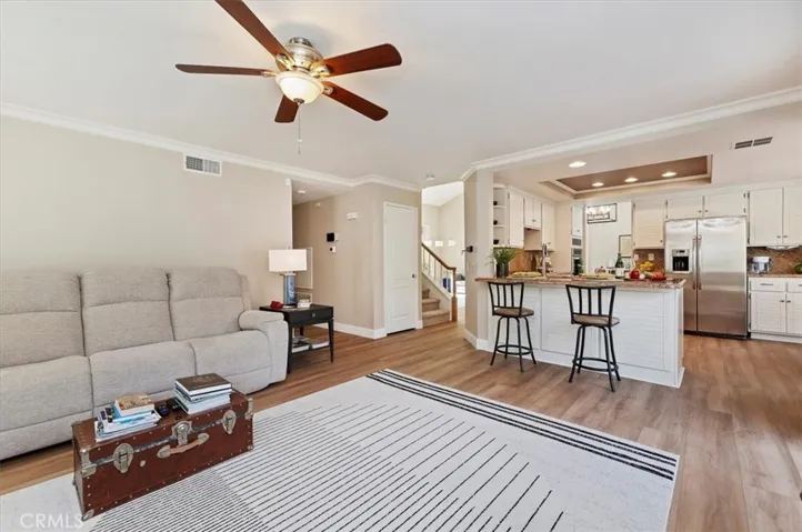View from family room into the kitchen area. Neutral colors, lots of natural lighting