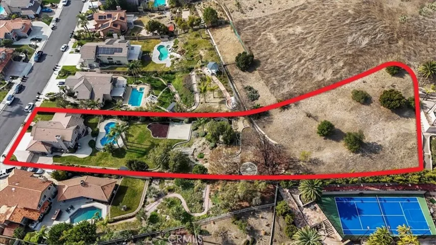The property line goes beyond the back fence. It does have some trees planted above. Use your imagination to decide what you would like to do. Lot is 35,200 sq.ft.  A little over 3/4 of an acre.