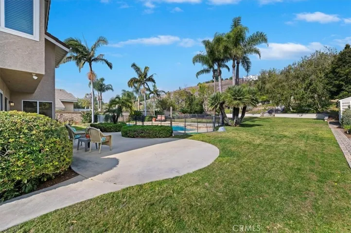 view of backyard from the RV parking area. Notice the large grass area perfect for playing games and look at the beautiful landscaping
