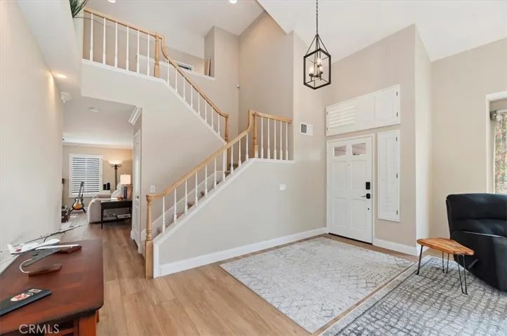 Soaring cathedral ceilings in foyer, living room and dining room creating a inviting atmosphere.  Freshly painted and new flooring