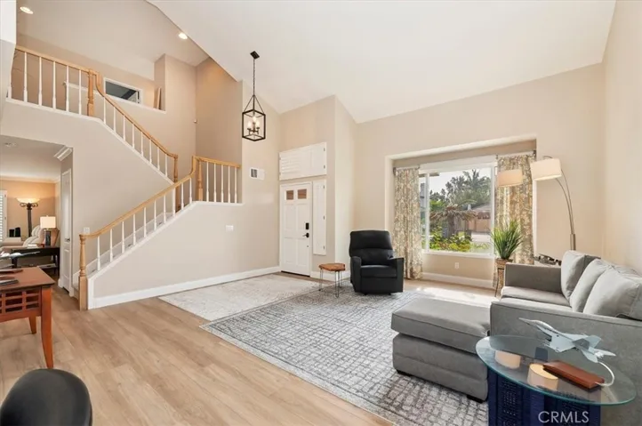 View of from the dining room into foyer and living room. Interior Recently painted and new flooring too. You will notice that there are views from most windows throughout the home