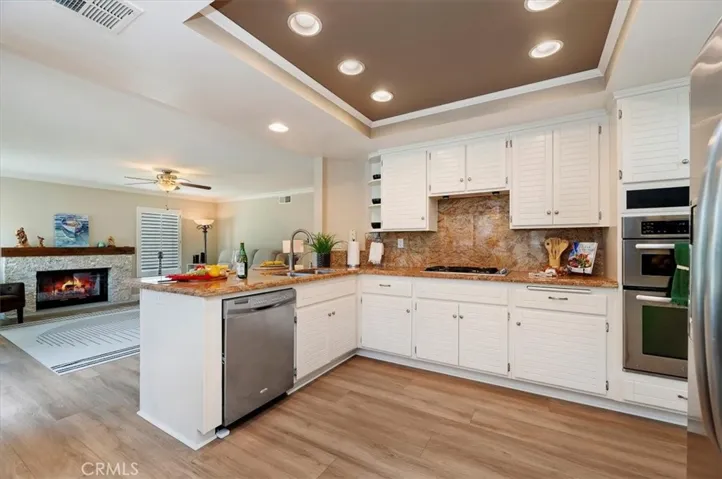The open kitchen into the breakfast nook and family room is perfect for family gatherings and entertaining guests or just relaxing in front of the TV