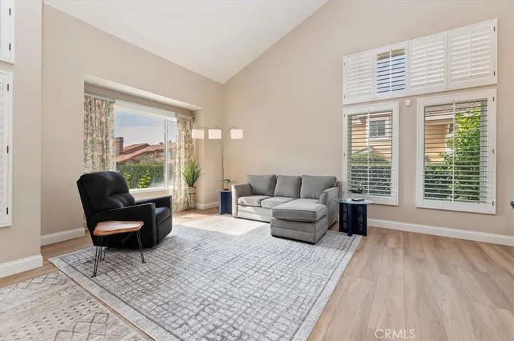 Another view of Living room, notice the large picture window perfect for showcasing your holiday decorations, especially your Christmas tree. Also notice the shutters and large baseboards