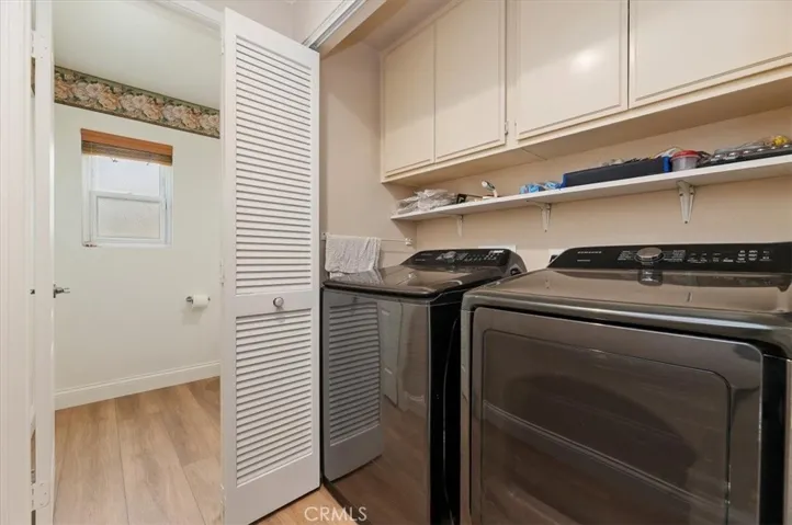 Inside laundry area with 220 outlet for electric dryer or gas hook up for dryer as well, build in shelve and cabinetry