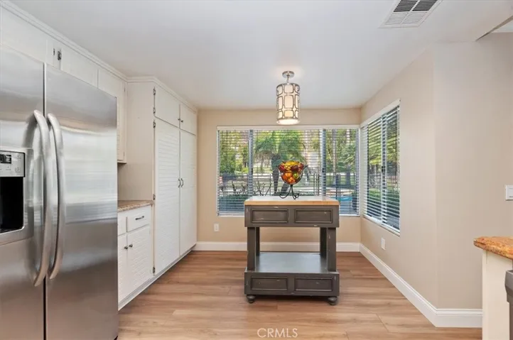 Another view of breakfast nook area. Notice the large pantry area on the left. Plus pool and spa just outside the window