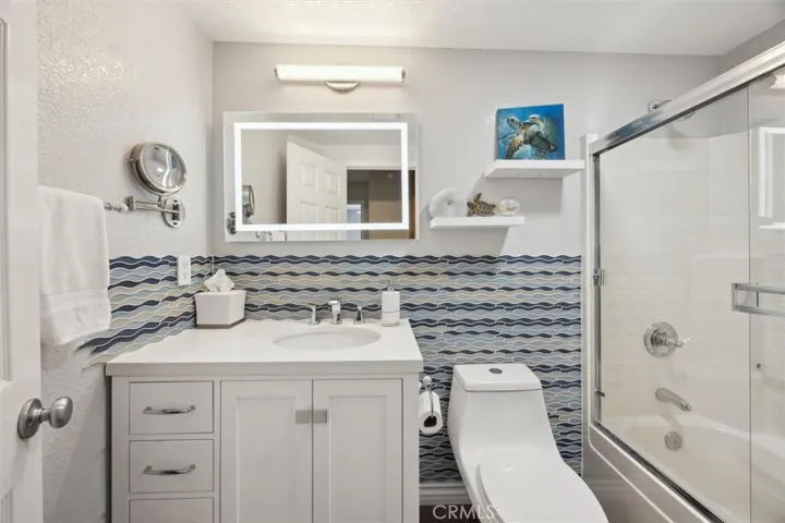 The hall bathroom also features a tub/shower, updated toilet and vanity and lighted mirror.