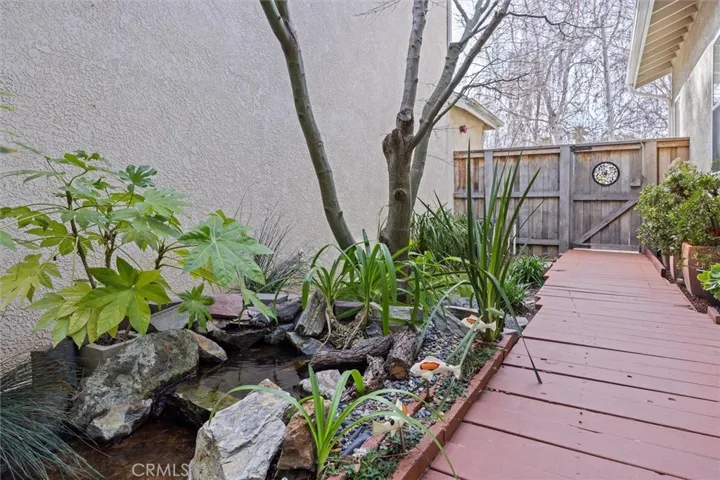 Listen to the sound of the waterfall into the pond. This development was built with zero lot lines, so each neighbor's house sits at the edge of the one beside it.