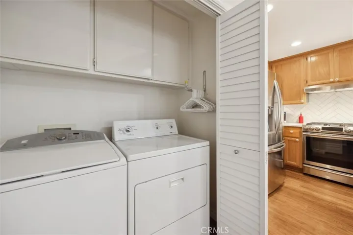 Washer and Dryer with cabinets for all the supplies.