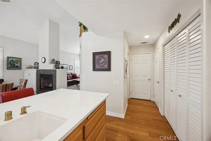 Hallway leads to the half bath on the left and the door to the garage at the end.