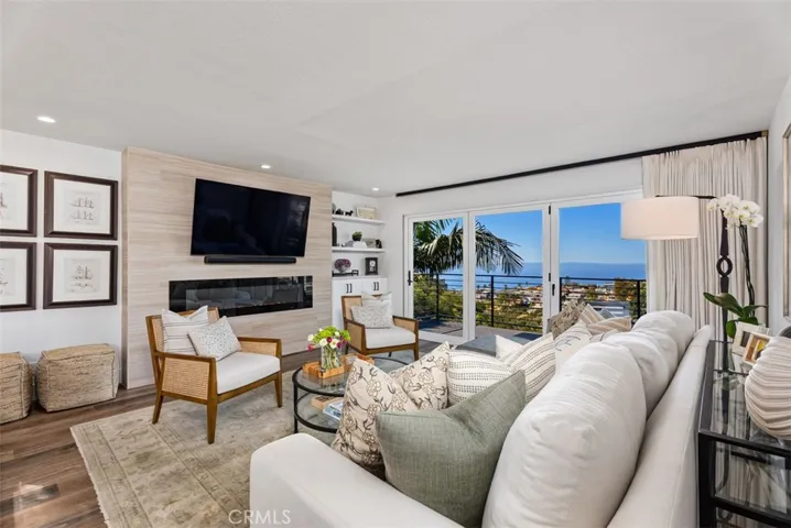 Living Room with Catalina Island & ocean views. Accordion doors open to balcony and views to capture the ocean breezes.
