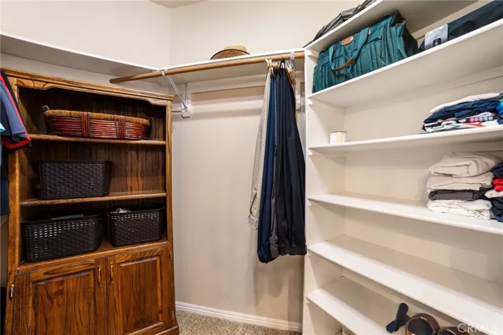 Primary walk-in closet for Him
