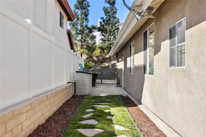 Side of house with smaller, gated RV parking.