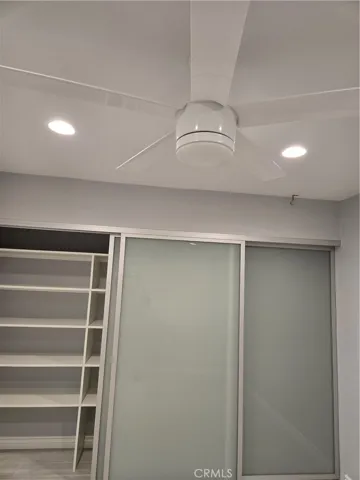 Master bedroom closet w/opaque glass inserts and storage racks...and canned lights too!