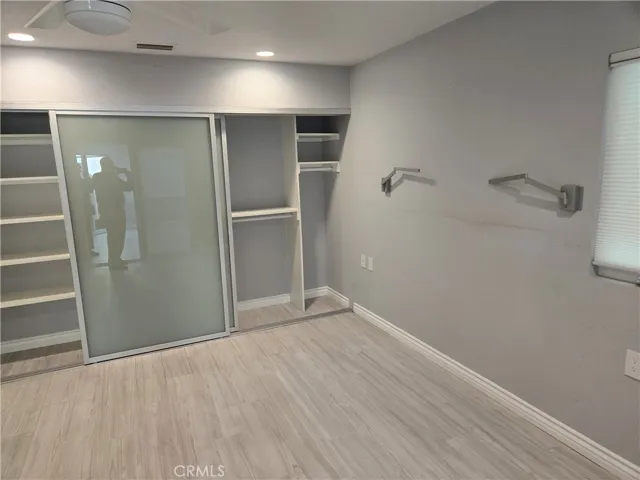 Master closet with opaque glass inserts & wall mounted reading lights for bedtime