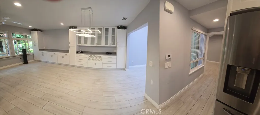 Living and dining rooms with enclosed atrium to right